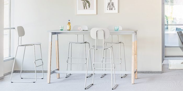 Canteen table with a grey top and wood legs