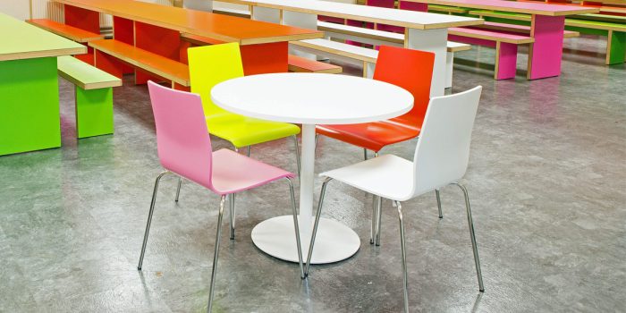 Round white Inox table with colourful chairs