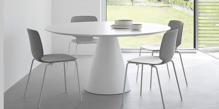 Large round meeting table with grey chairs