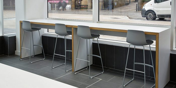 Long white high canteen table with stools