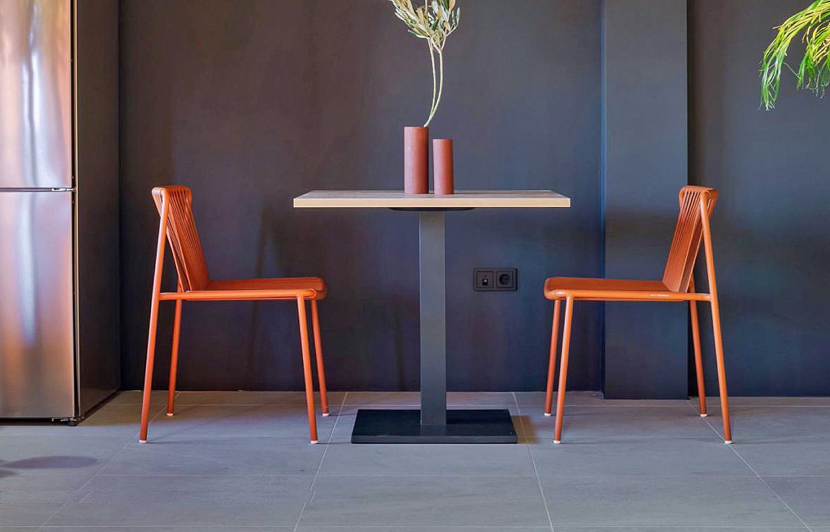 Black wood table with an orange chair