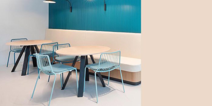 Blue metal chair with black round table