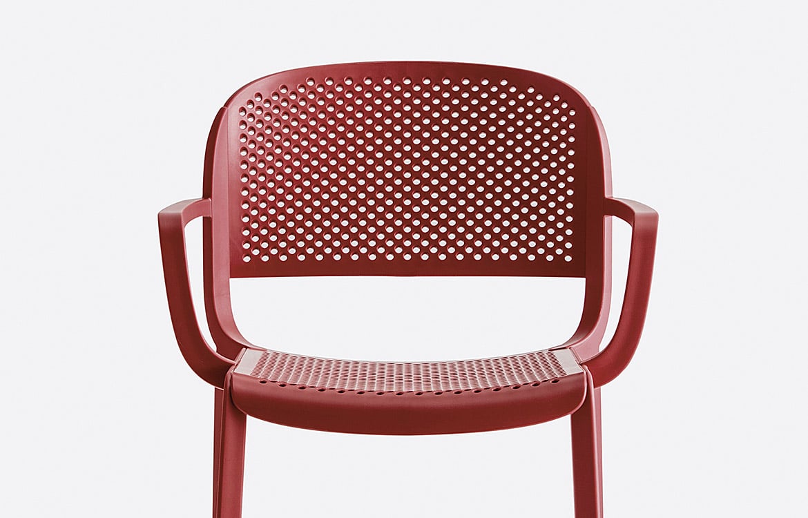 Red cafe chair with drain holes