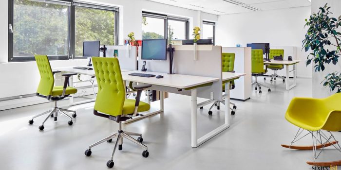 Office with green buttoned desk chairs