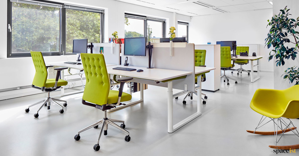 Office with green buttoned desk chairs