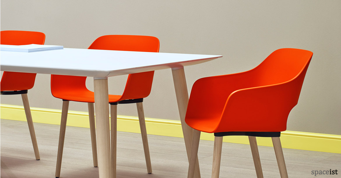 Babila white wood meeting table with orange chairs