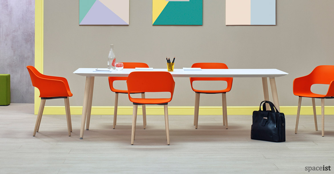 Babila white meeting table with orange meeting chairs