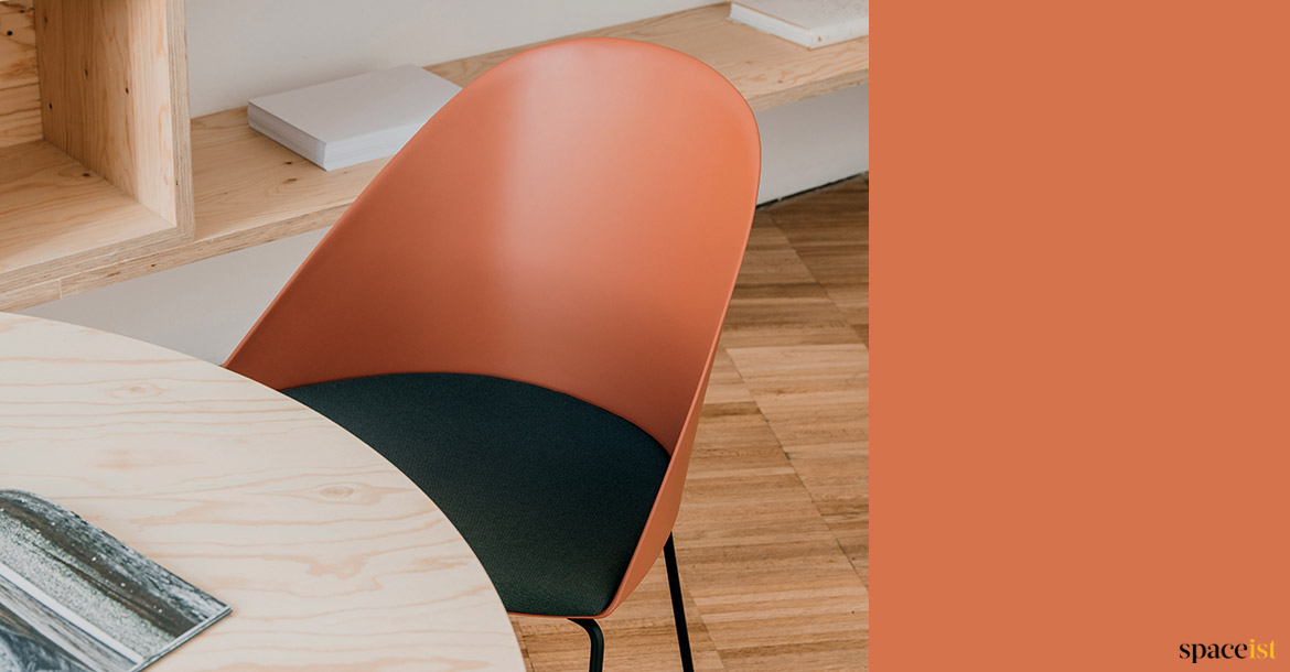 Orange chair with black seat