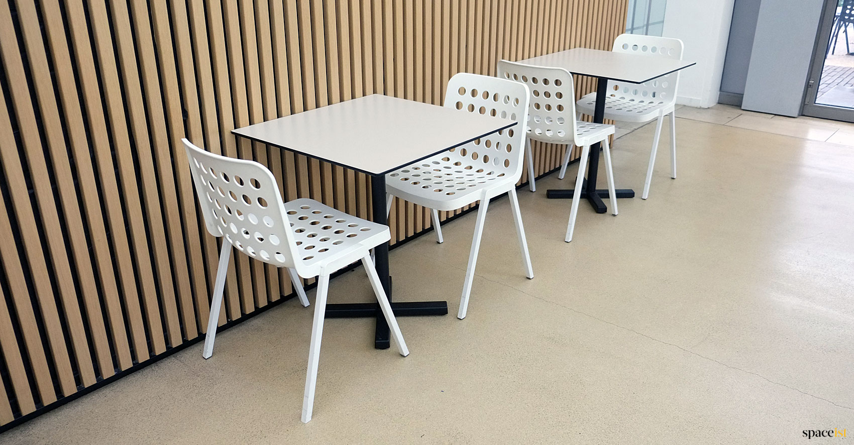 White cafe chairs with holes in seat