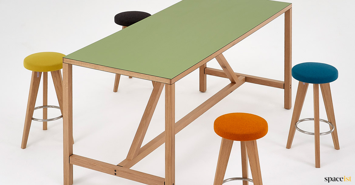 Green modern table with wood supports