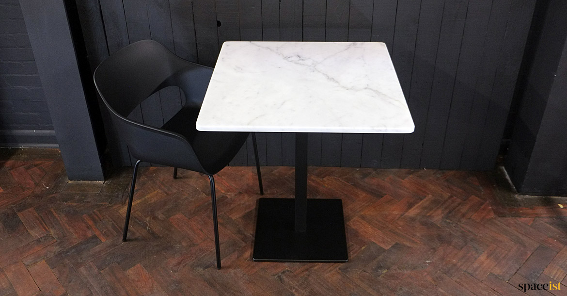 White marble top with black chair