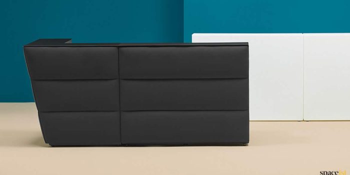 Black reception desk with fabric front