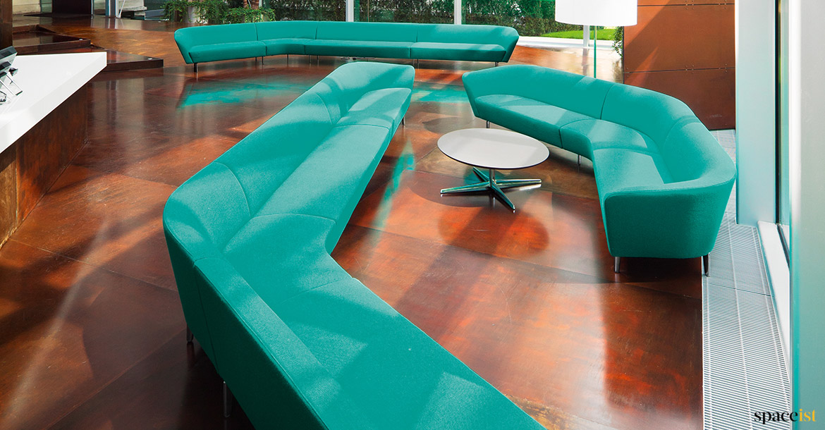 Group of green sofas in reception area