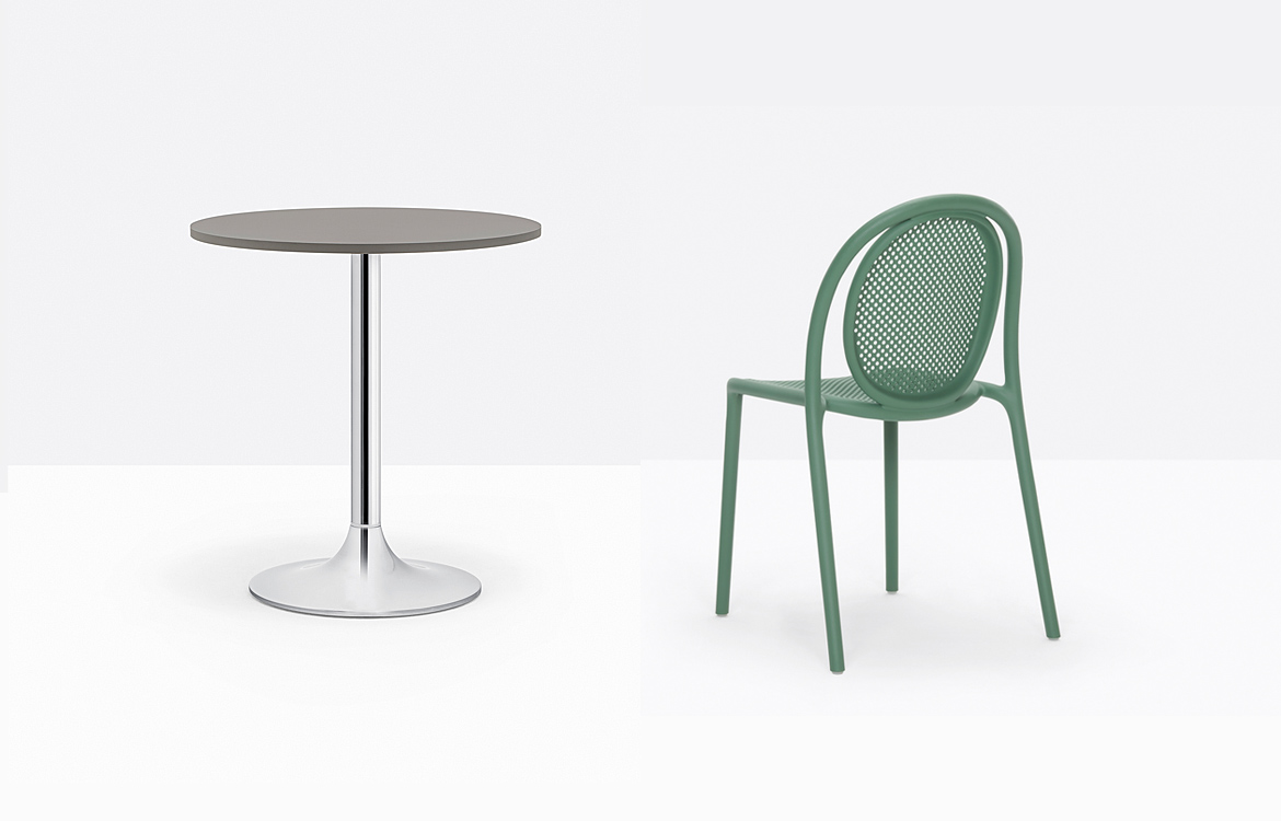 Trumpet style table with a green chair