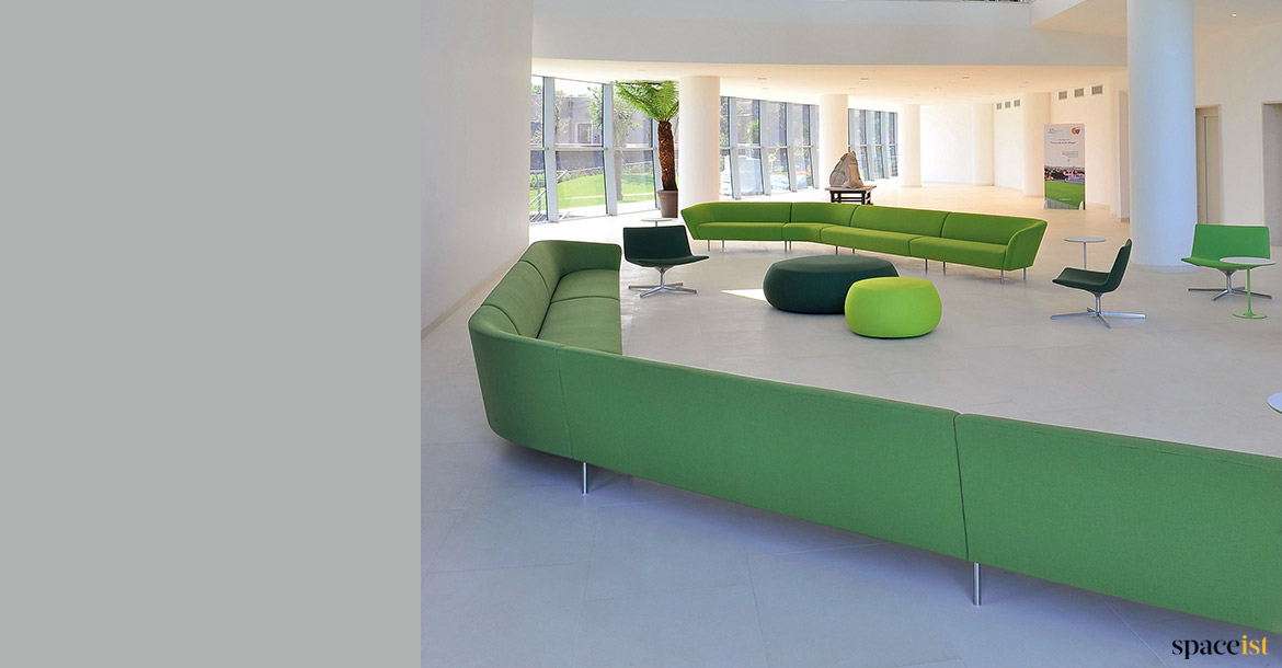 Long green sofa angled in modern room