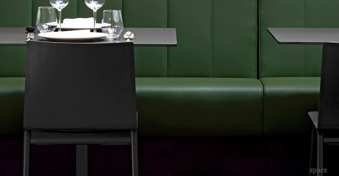 Saka wood chairs in a black close-up