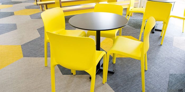 bold black tables with yellow cafe chairs