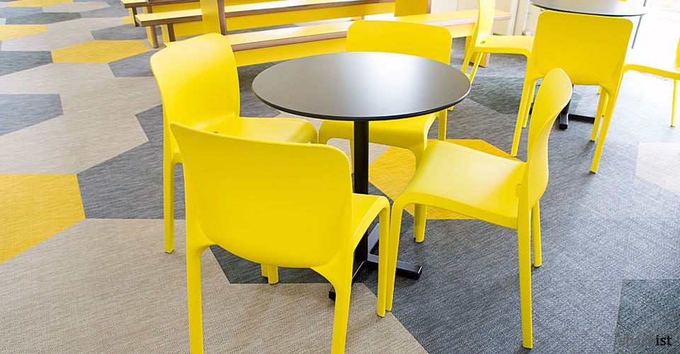 bold black tables with yellow cafe chairs
