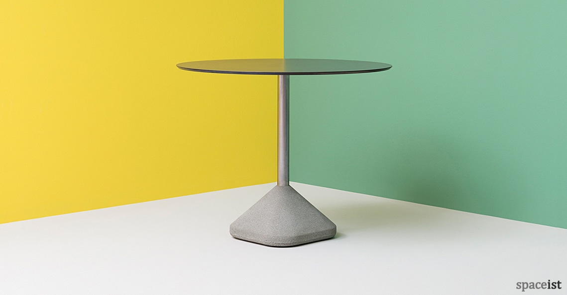 Concrete cafe table with a black round top