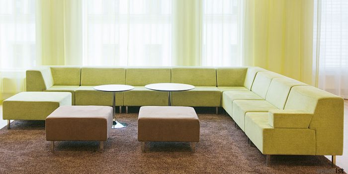 green modular sofa with round coffee tables